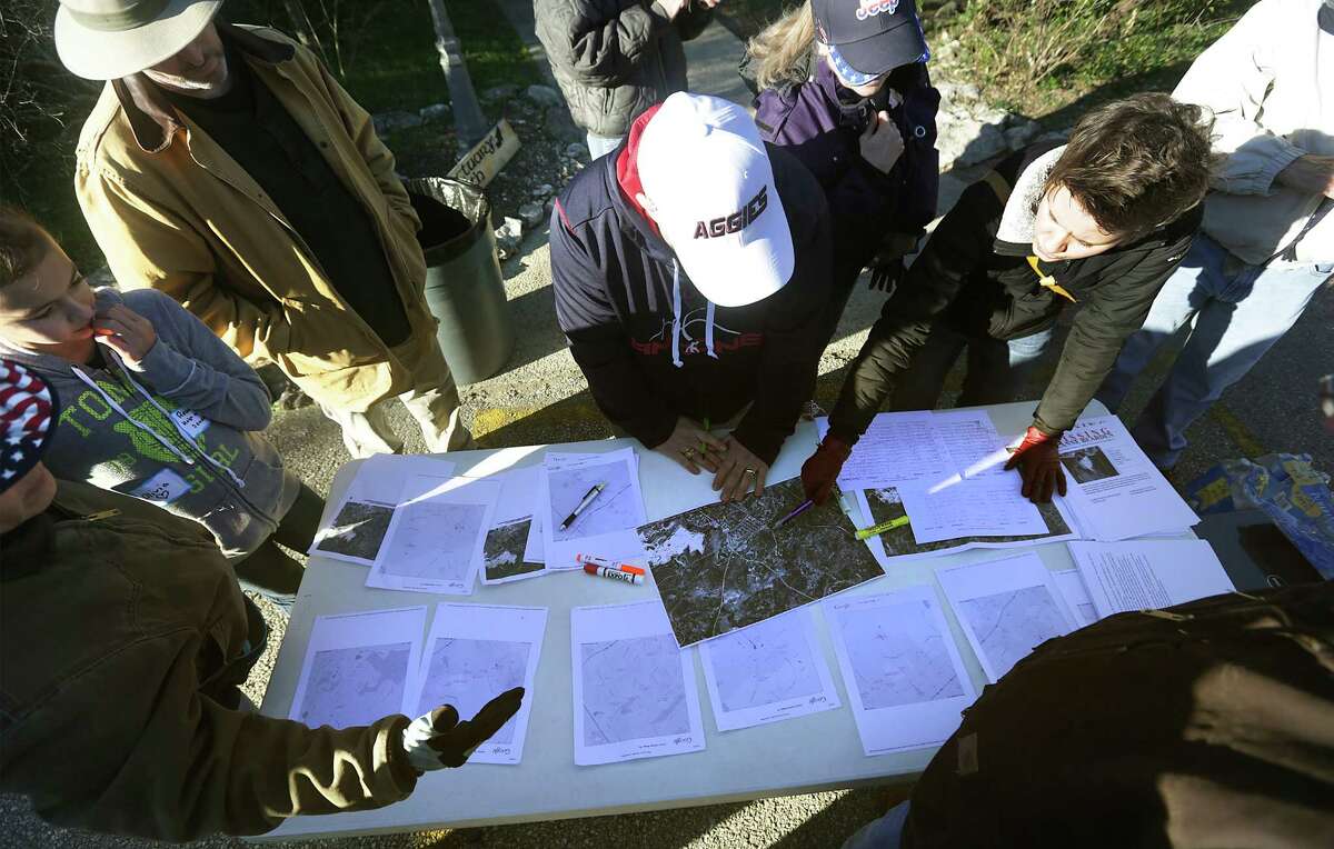 Volunteers surround a table of area maps to search in Garden Ridge close to where Leanne Bearden was last seen. She has been missing since Jan. 17. Forty four volunteers signed up at Covenant Baptist Church for the search organized by friends and family members. Wednesday, Jan. 22, 2014.