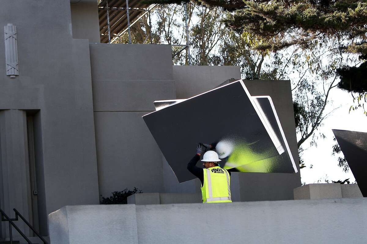 Leonardo Gutierrez of Anvil Builders brings protective panels in to put over the murals in Coit Tower while the building is closed for repairs in San Francisco, Calif., on Wednesday, January 22, 2014.