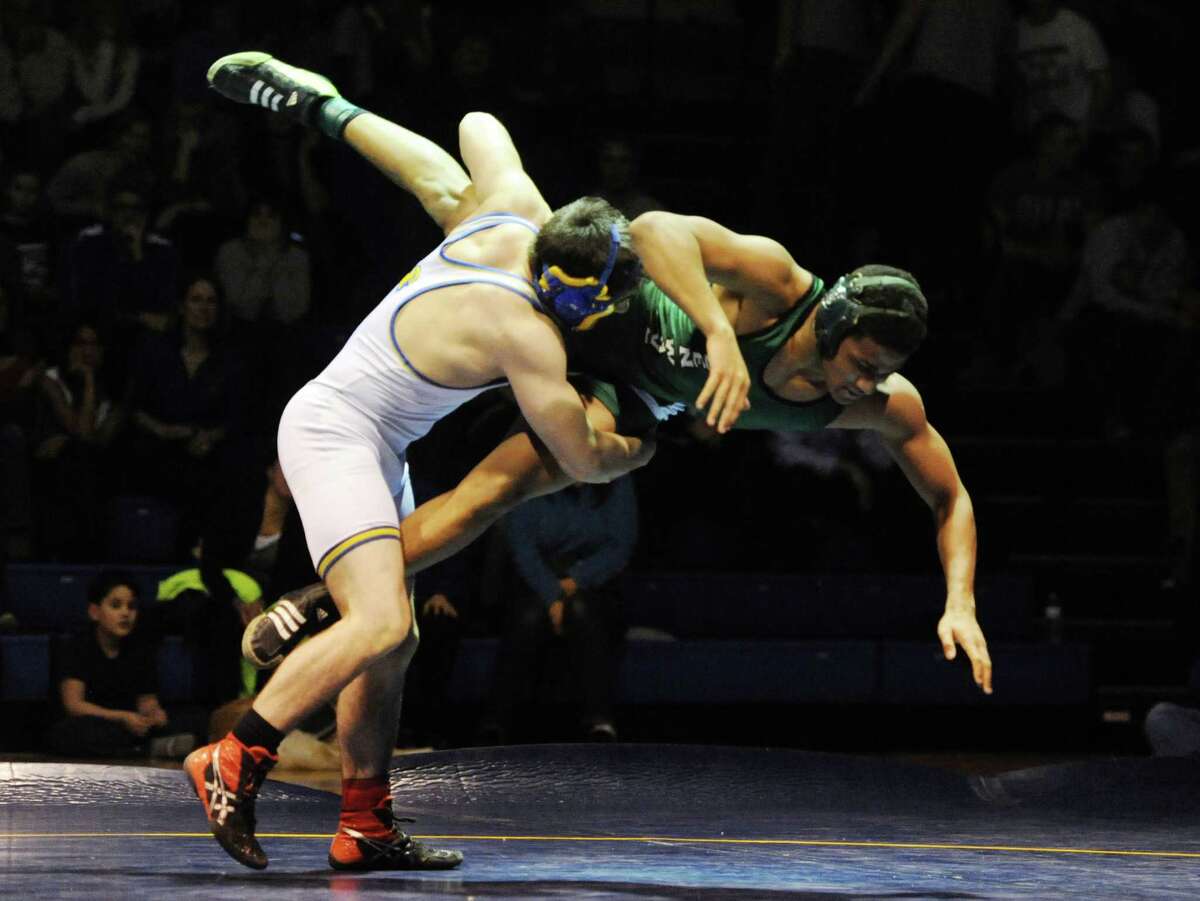 _ wrestles _ in the _ pound match during New Milford's 36-29 win over Newtown at Newtown High School in Newtown, Conn. on Wednesday, Jan. 22, 2014.