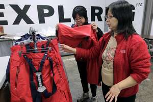 Seamstress Betty Beh (left) and supervisor Lydia Lam, inspect a line of outerwear designed for the U.S. Olympic freeskiing team at the North Face development center in San Leandro, Calif. on Wednesday, Jan. 15, 2014. The longtime Bay Area outdoor clothing and equipment company is outfitting the U.S. Olympic freeskiing team competing in Sochi, Russia. The limited edition clothing on the racks will be available to the public.
