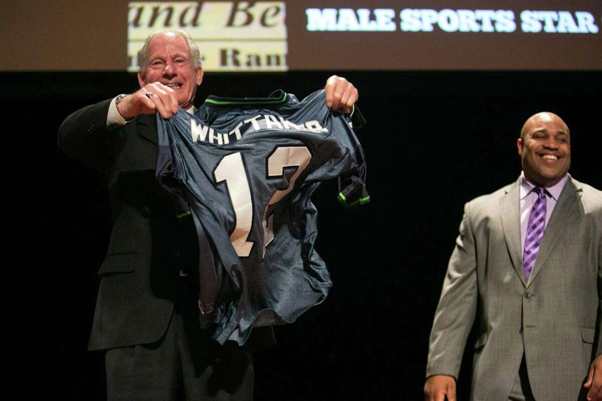 Mountaineering legend Jim Whittaker holds up his 12th Man jersey during the 79th annual Sports Star of the Year awards on Wednesday, January 22, 2014 at Benaroya Hall in Seattle. The event, started by longtime P-I sports editor Royal Broughham, honors top local athletes.