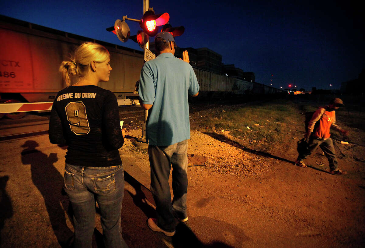 Scott Ackerson, center, Vice President of transformational services at Haven for Hope, and Jamie Stephens, left, also from Haven for Hope, greet a homeless man at the train crossing on Commerce St. The City of San Antonio and Haven for Hope conducted a point in time head count of homeless individuals in the downtown area, Tuesday, Oct. 19, 2010. Photo Bob Owen/rowen@express-news.net