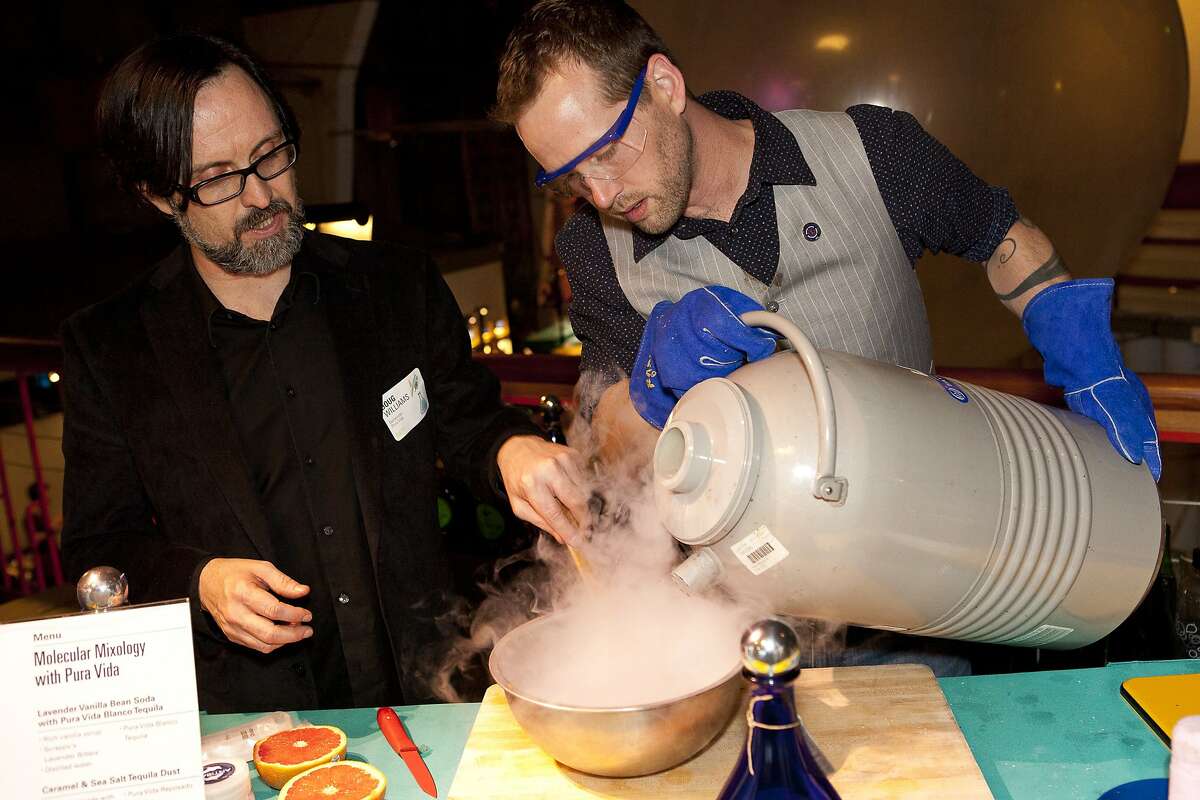 Mixologists Doug Williams and Tom Mich use liquid nitrogen during a molecular mixology demonstration at the Exploratorium's Science of Cocktails in 2012.