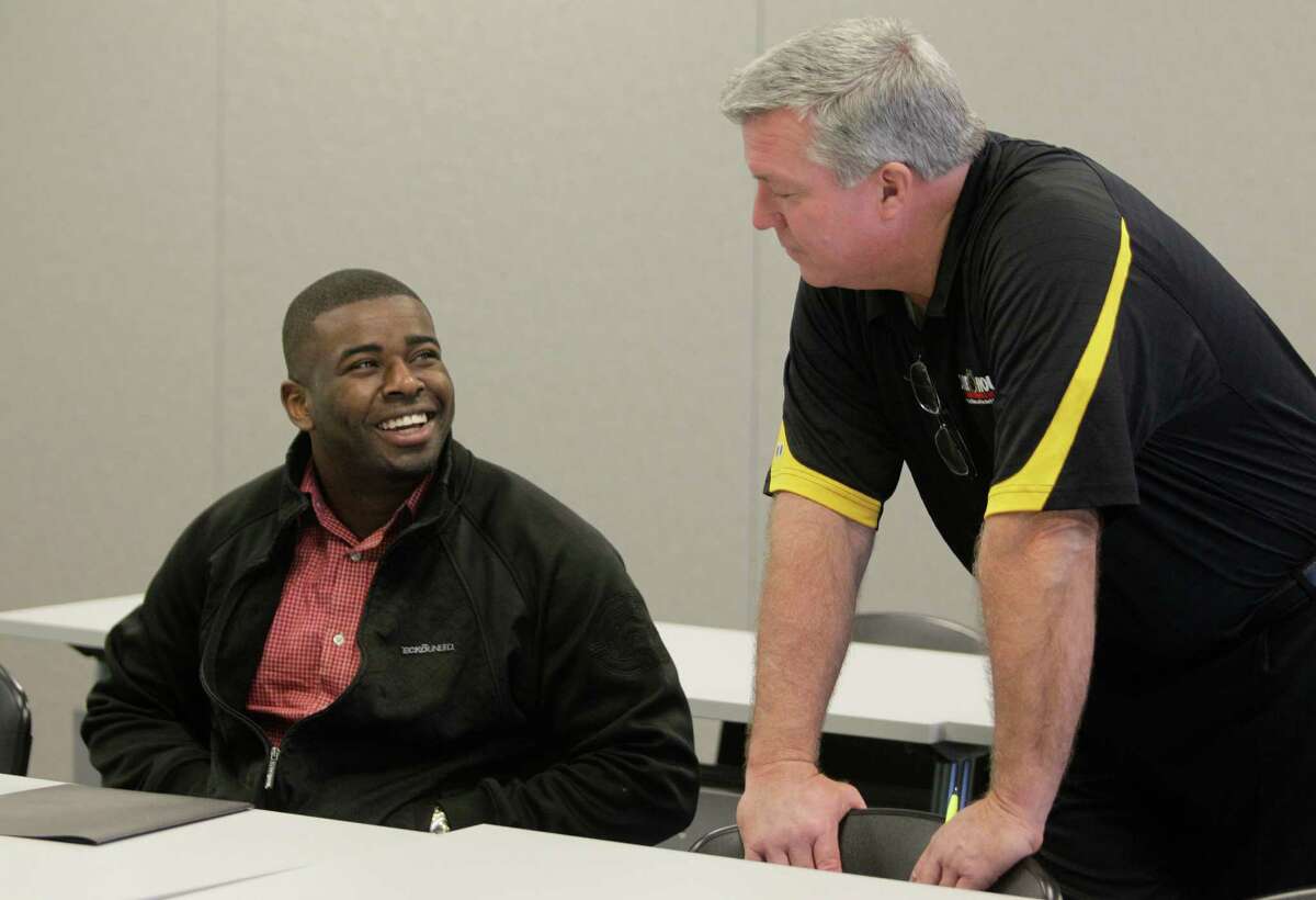 Applicant Deonte Morris, left, of Houston talks with K.C. Arnold, sales manager, during a hiring event at One Hour Air Conditioning and Heating.