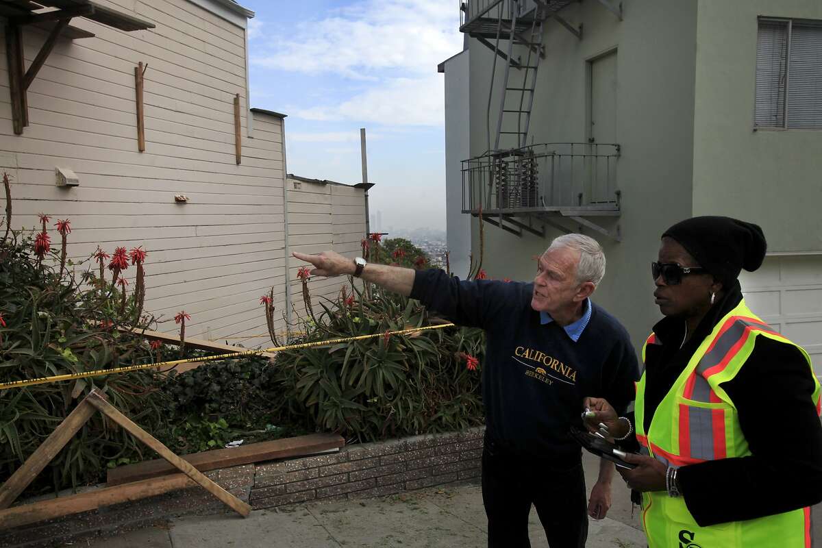 Neighbor Chris Smith, left, recounts a scaffolding accident he heard to a San Francisco Department of Public Works employee that happened on the house at left Jan. 24, 2014 at a house under construction near Eureka Valley in San Francisco, Calif. Three construction workers sustained non-life-threatening injuries when their scaffolding collapsed under their combined weight and they fell over 15 feet to the ground below.