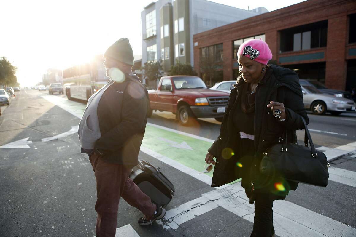 Phyllis Trammell, 72, and her developmentally disabled son Louis Williams, 42, walk through the SOMA district ats they head for the St. Vincent de Paul shelter in hopes of finding a bed for the night, in San Francisco, CA, Thursday, January 23, 2014. Phyllis and her son Louis have recently become homeless after losing their hotel in Sacramento and have been living on the streets of San Francisco for the last three weeks.