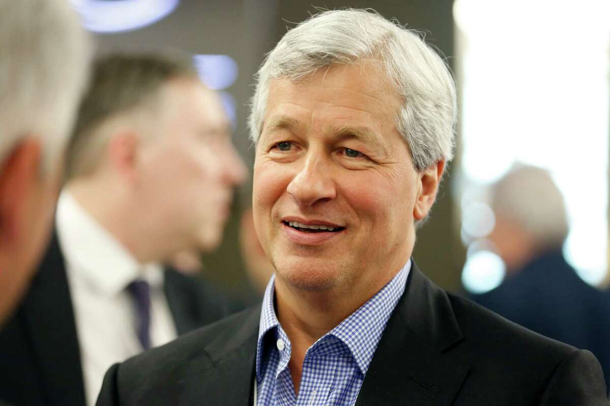 James 'Jamie' Dimon, chief executive officer of JPMorgan Chase & Co., speaks with delegates during a break in sessions on the opening day of the World Economic Forum (WEF) in Davos, Switzerland, on Wednesday, Jan. 22, 2014. World leaders, influential executives, bankers and policy makers attend the 44th annual meeting of the World Economic Forum in Davos, the five day event runs from Jan. 22-25. Photographer: Jason Alden/Bloomberg *** Local Caption *** James Dimon