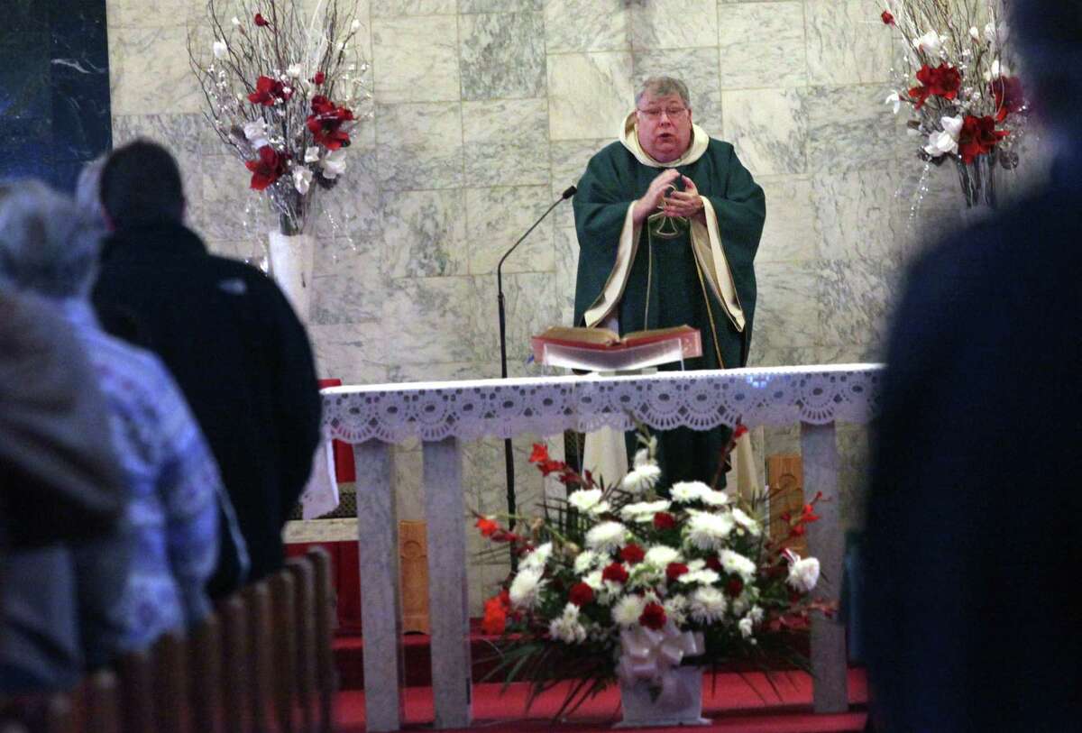 Monsignor Martin Ryan says mass at Our Lady of Grace Church in Stratford, Conn. on Monday, Jan. 26, 2014.