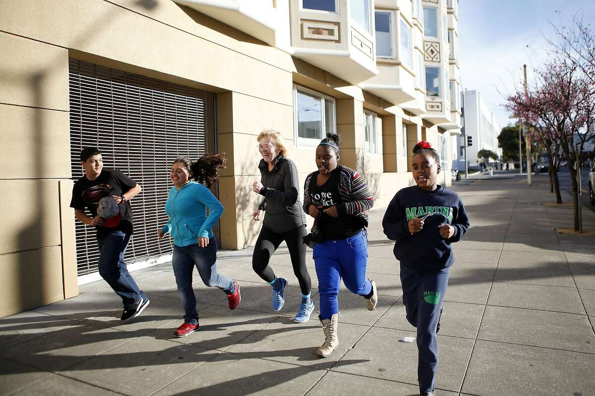 Marina Middle School Assistant Principle Ginny Daws, center, takes students (L-R) Ivan Ortega, Sofia Sanchez, Tyler Tukes and Tre'jor Barber for a run, in the Marina District of San Francisco, CA, Tuesday, January 21, 2014. In a move that has seen a decrease of suspensions, Assistant Principle Ginny Daws has started running with some students after class, an activity and approach that is part of a big shift in how the district deals with defiant kids.