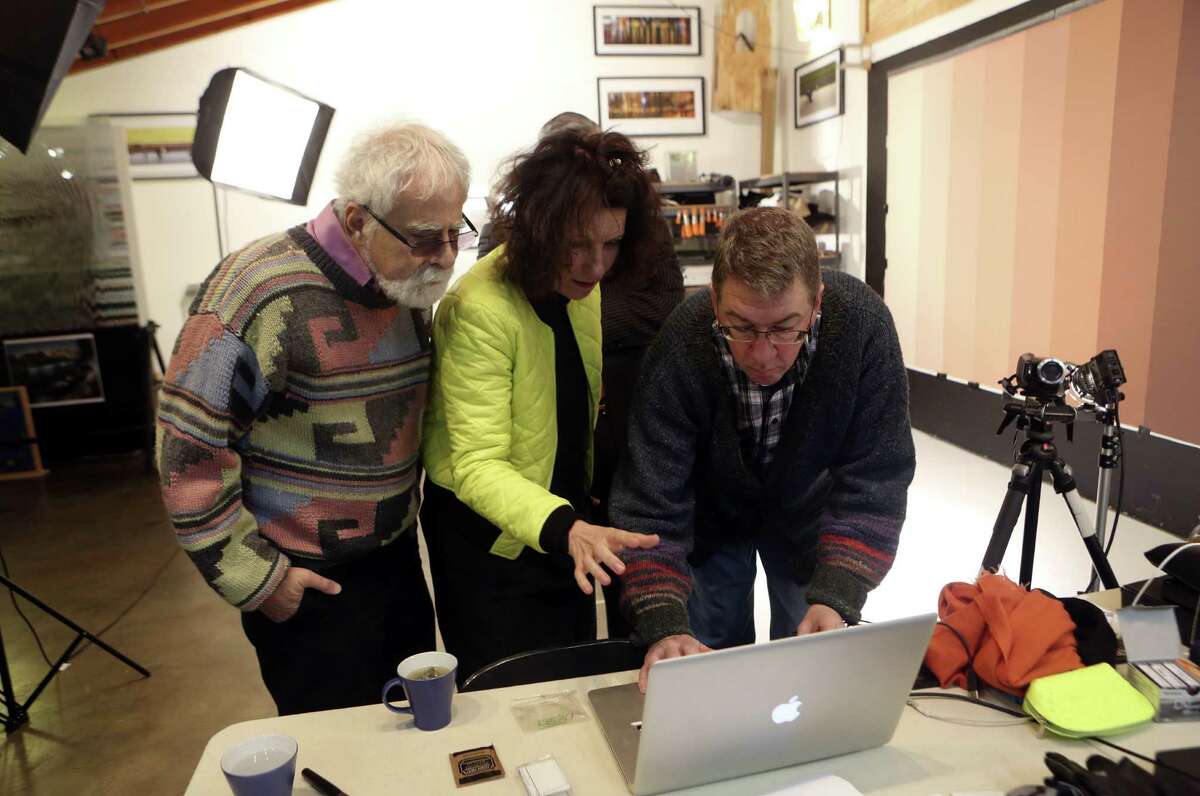 David Rubin (from left), French video artist Sylvie Blocher and Ansen Seale view footage Blocher filmed in Seale's studio.