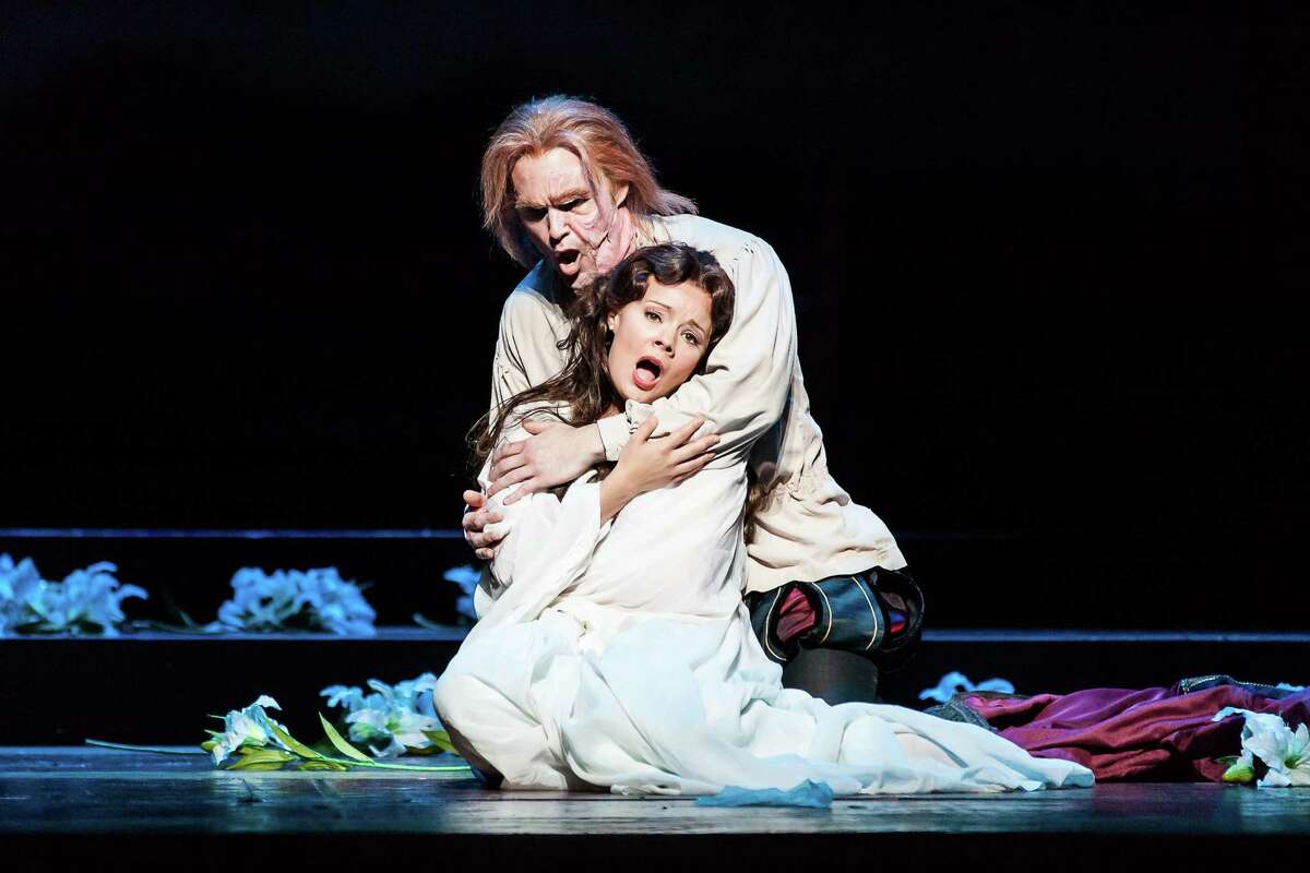 Rigoletto, played by Ryan McKinny, consoles his daughter, Gilda, played by Uliana Alexyuk, in Houston Grand Opera's staging of Giuseppe Verdi's "Rigoletto."