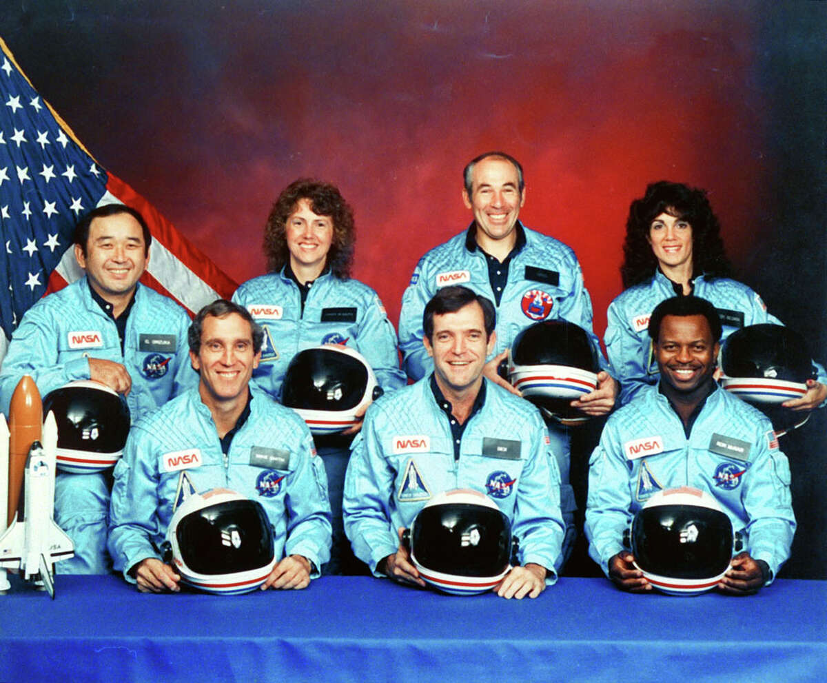 The crew of Space Shuttle Challenger X is seen in November 1985 at Johnson Space Center. Front row, from left: Michael J. Smith, Francis R. Scobee and Ronald E. McNair. Back row, from left: Ellison S. Onizuka, Christa McAuliffe, Gregory B. Jarvis and Judith A. Resnik.