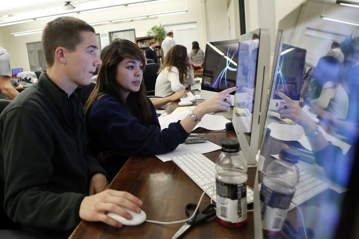 Students Matt Finkle, left, and Perry Costa work on laying out the monthly print edition of their school newspaper the Redwood Bark, at Redwood High School in Larkspur, CA, Tuesday, January 28, 2014. Since the 1970s the newspaper staff at Redwood High School has been doing a student sex survey and Friday will be the 40th survey to be printed in the monthly Redwood Bark newspaper.
