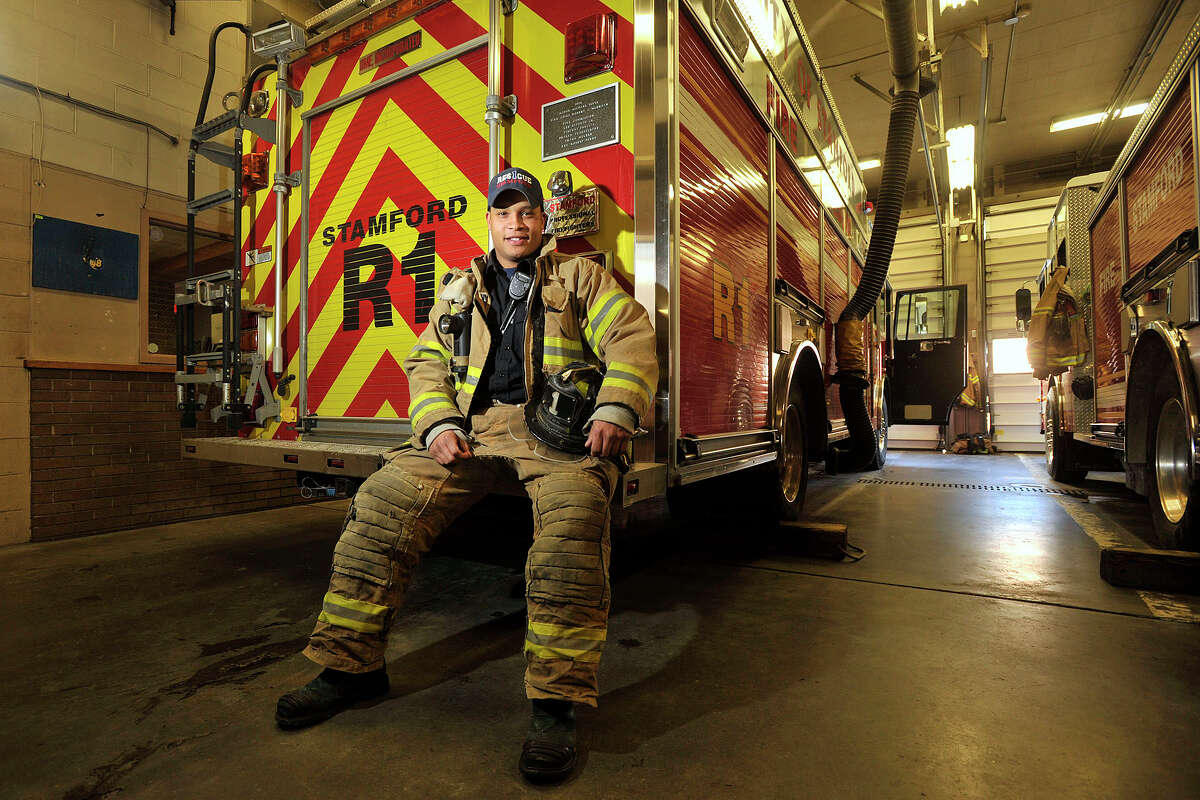 Stamford firefighter Zachary McArthur poses for a photograph at Station 5 in Stamford, Conn., on Thursday, Jan. 30, 2014. McArthur saved a dog from a burning building in Cheshire on Tuesday while on a trip to see family.