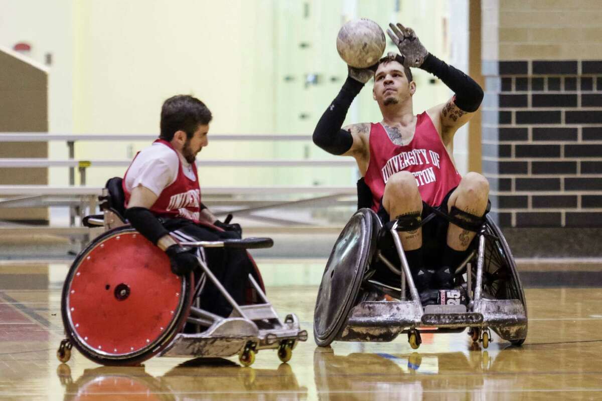 Eric Ingram, left, and Mason Symons get in some wheelchair rugby practice time at the University of Houston, which this weekend is hosting a tournament.