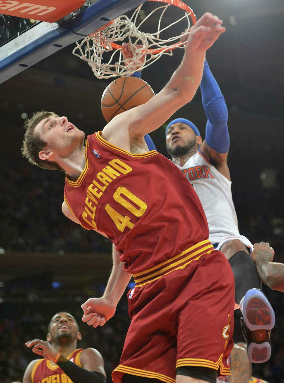 New York Knicks' Carmelo Anthony dunks the ball over Cleveland Cavaliers' Tyler Zeller (40) during the first quarter of an NBA basketball game Thursday, Jan. 30, 2014, at Madison Square Garden in New York. (AP Photo/Bill Kostroun) ORG XMIT: NYBK102