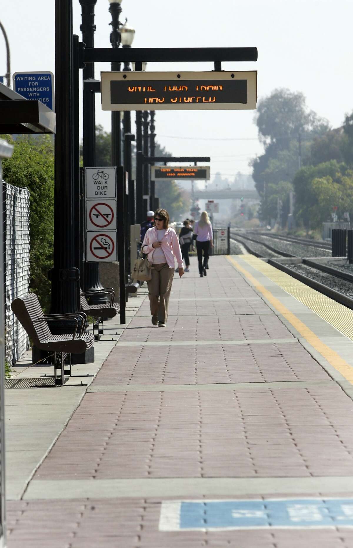In this file photo, people walking about at the Caltrain station in Redwood City.