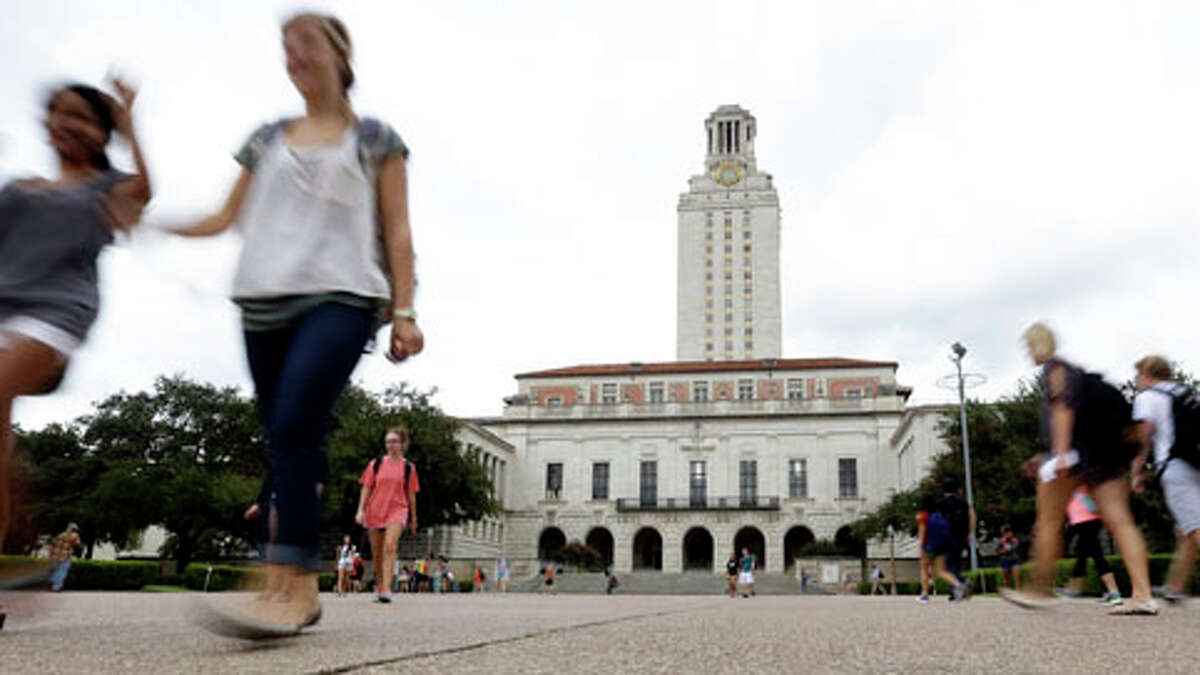 In this Thursday, Sept. 27, 2012 photo, students walk through the University of Texas at Austin campus near the school's iconic tower in Austin, Texas. 