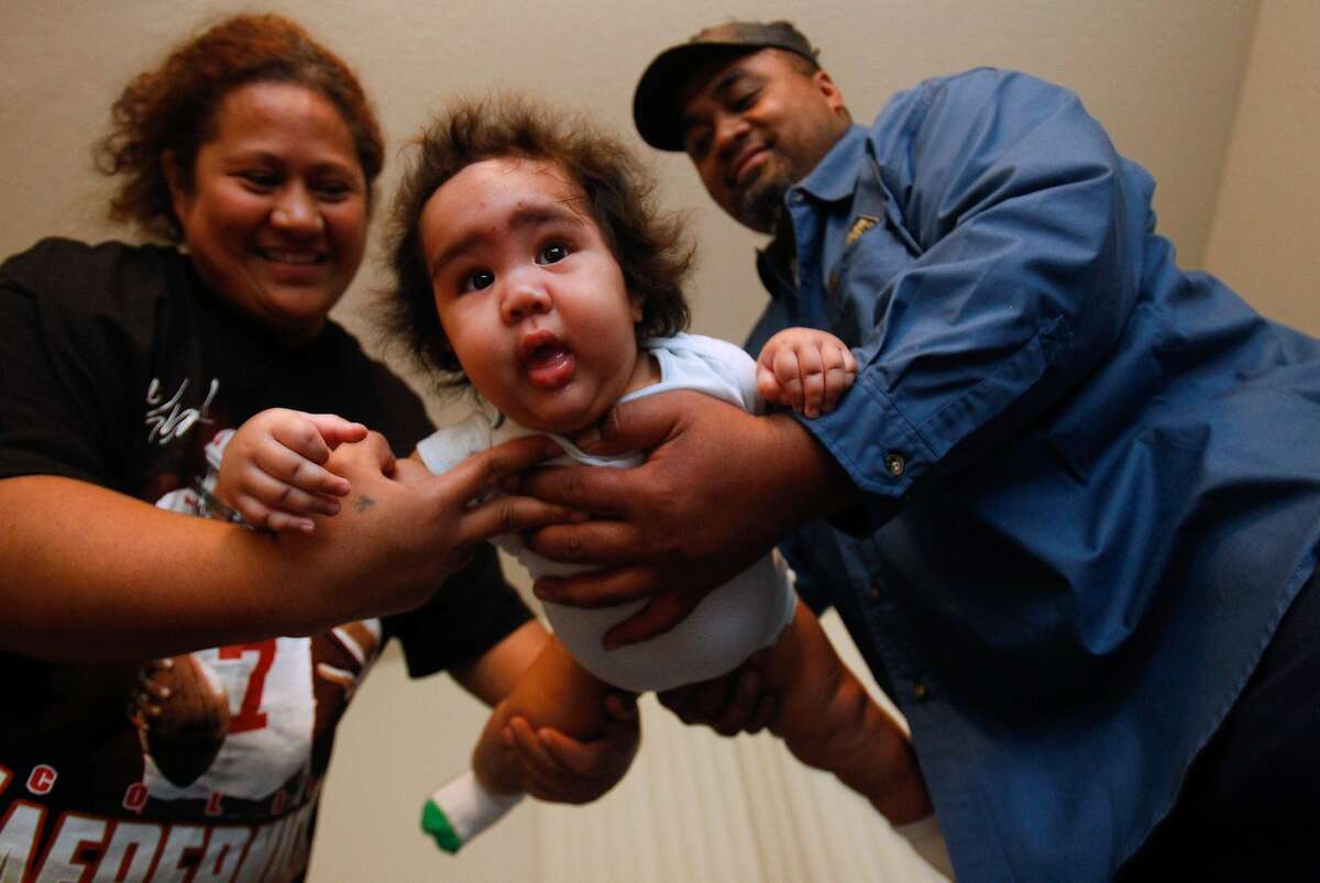 Pava Otuhiva, right, and Sosefina Tagalu, hold their son, Sammisano Otuhiva, five months, at their home in Daly City, Calif., on Thursday, Jan. 30, 2014. The younger Otuhiva was 16 lbs. 1.74 oz. at birth.