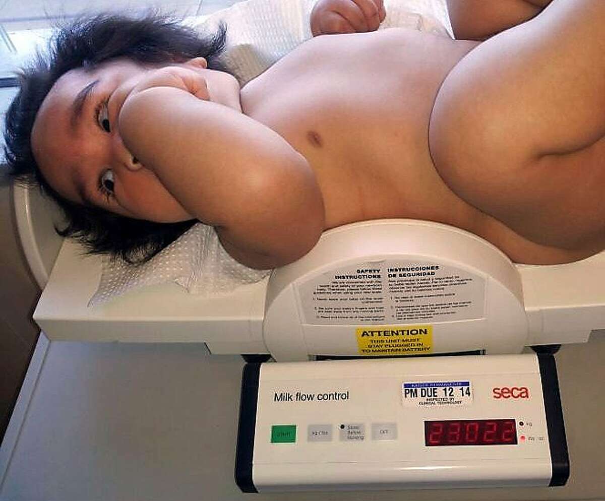 Sammisano Otuhiva being weighed during a doctor's visit in December.