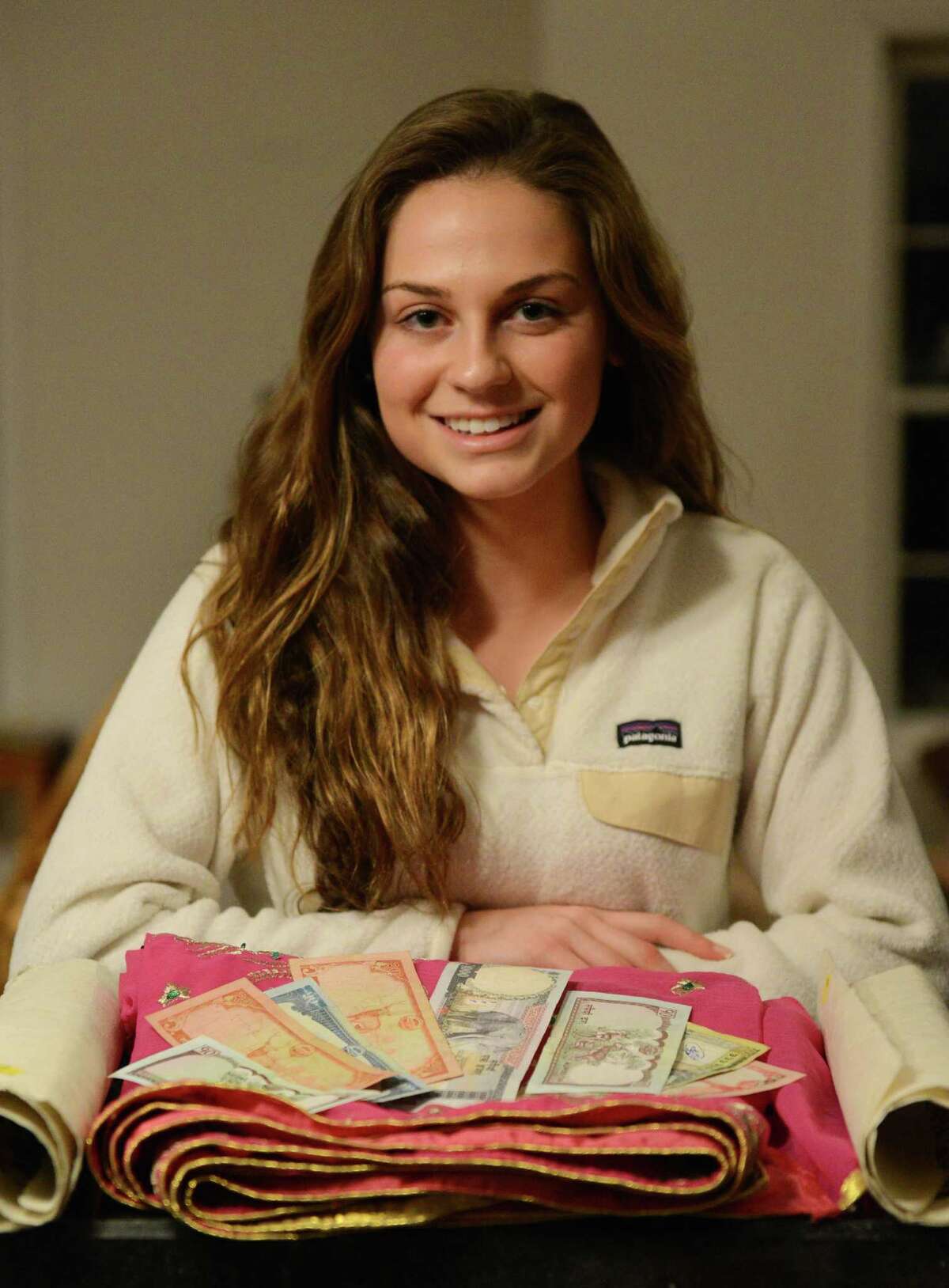 Taylor Weston, a senior at Shepaug Valley High School, poses with souvenirs from her recent trip to Nepal in her Bridgewater, Conn. home on Monday, Jan. 27, 2014. Weston was in Nepal from Dec. 7 through Dec. 17 for an exploratory project through Doctors Without Borders to investigate and compare the medical facilities in Nepal to those in the United States. For her senior project, "Exploring Medicine in Nepal," Weston will discuss her findings.