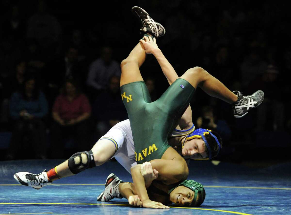 Newtown's Alex Stzbola slams New Milford's Isaiah Jenkins to the mat in the 152 pound match during New Milford's 36-29 win over Newtown at Newtown High School in Newtown, Conn. on Wednesday, Jan. 22, 2014.