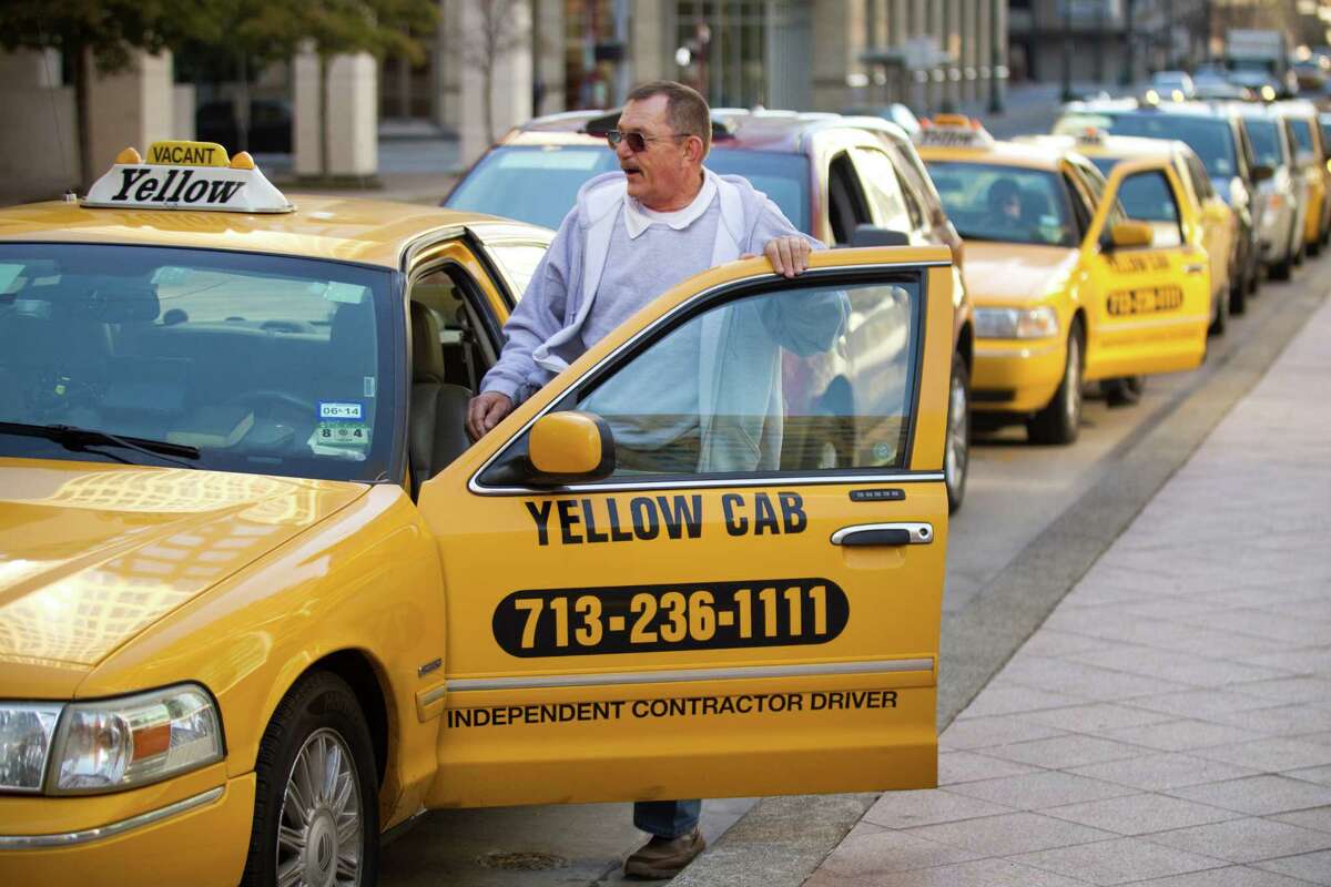 Taxi driver Chuck Peto gets in his car while waiting for a fare at a cab stand on Milam downtown.