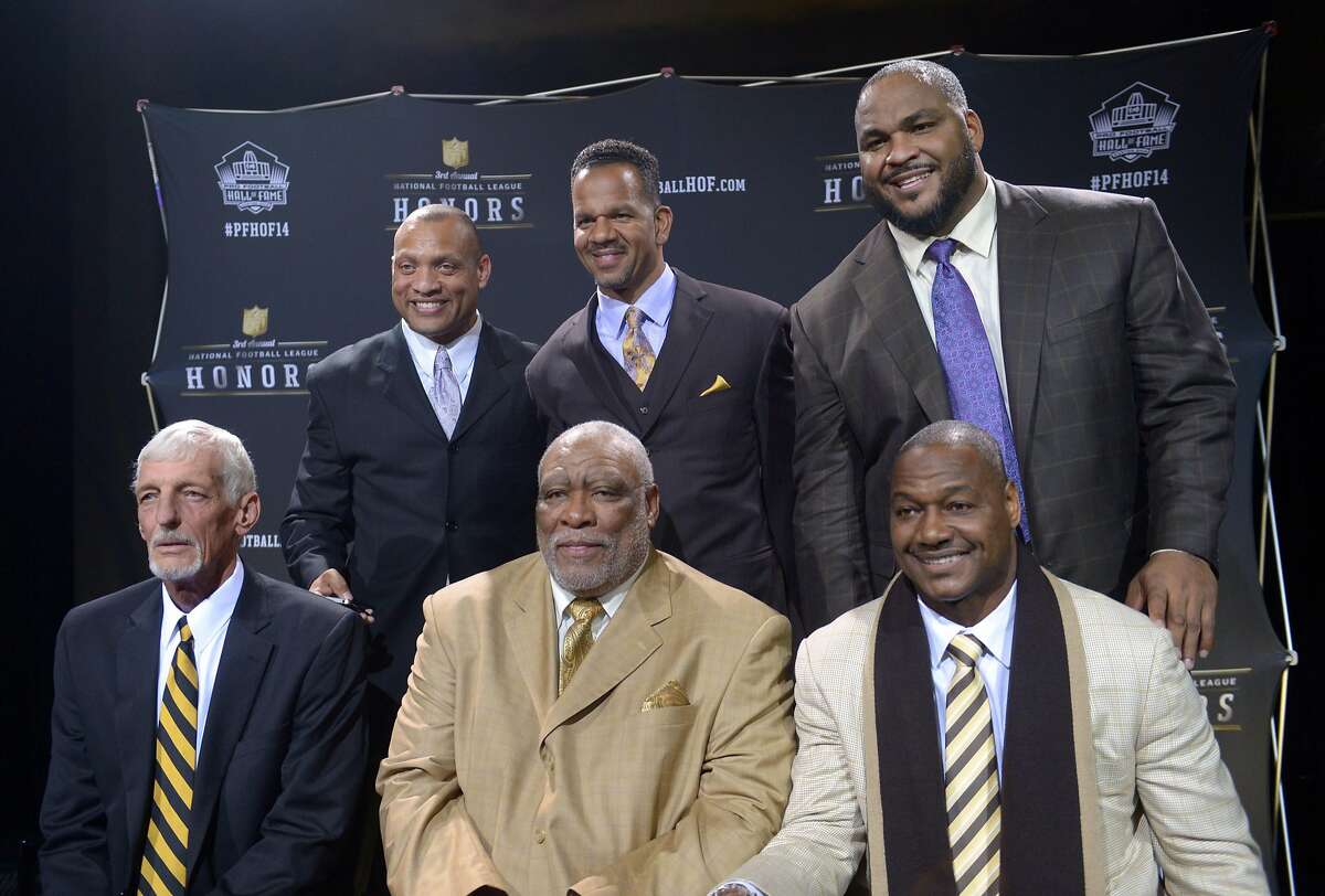 Feb 1, 2014; New York, NY, USA; Members of the 2014 Pro Football Hall of Fame class pose at the 3rd NFL Honors at Radio Music City Hall. Front row (from left): Ray Guy and Claude Humphrey and Derrick Brooks. Back row: Aeneas Williams and Andre Reed and Walter Jones. Mandatory Credit: Kirby Lee-USA TODAY Sports