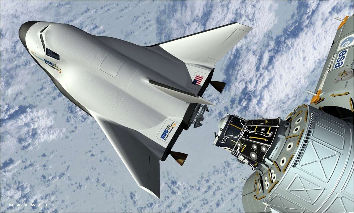 An artist's rendering shows Sierra Nevada Corp.'s Dream Chaser docking with the International Space Station. The company is competing with SpaceX and Boeing for NASA funds.