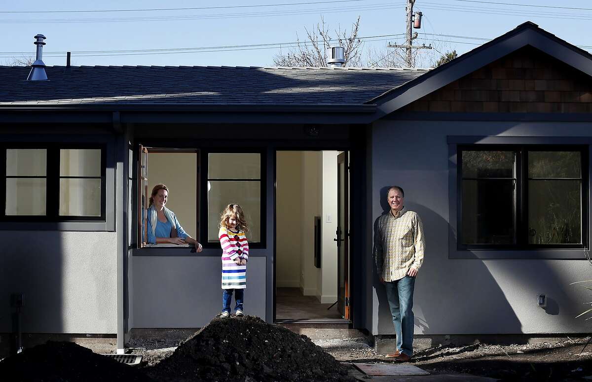 Bruce and Nancy Chamberlain and their daughter Lillie, 5, with the cottage they built in their backyard for extra space in Berkeley, Calif., on Saturday, February 1, 2014.
