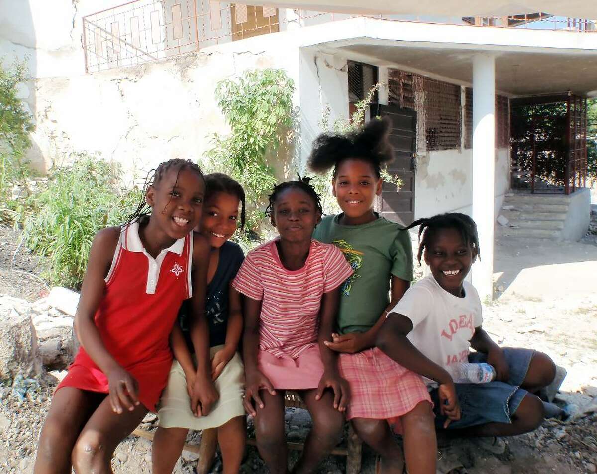 Children smile as they pose for a photo, survivors of the earthquake in Haiti, Jan. 2010.