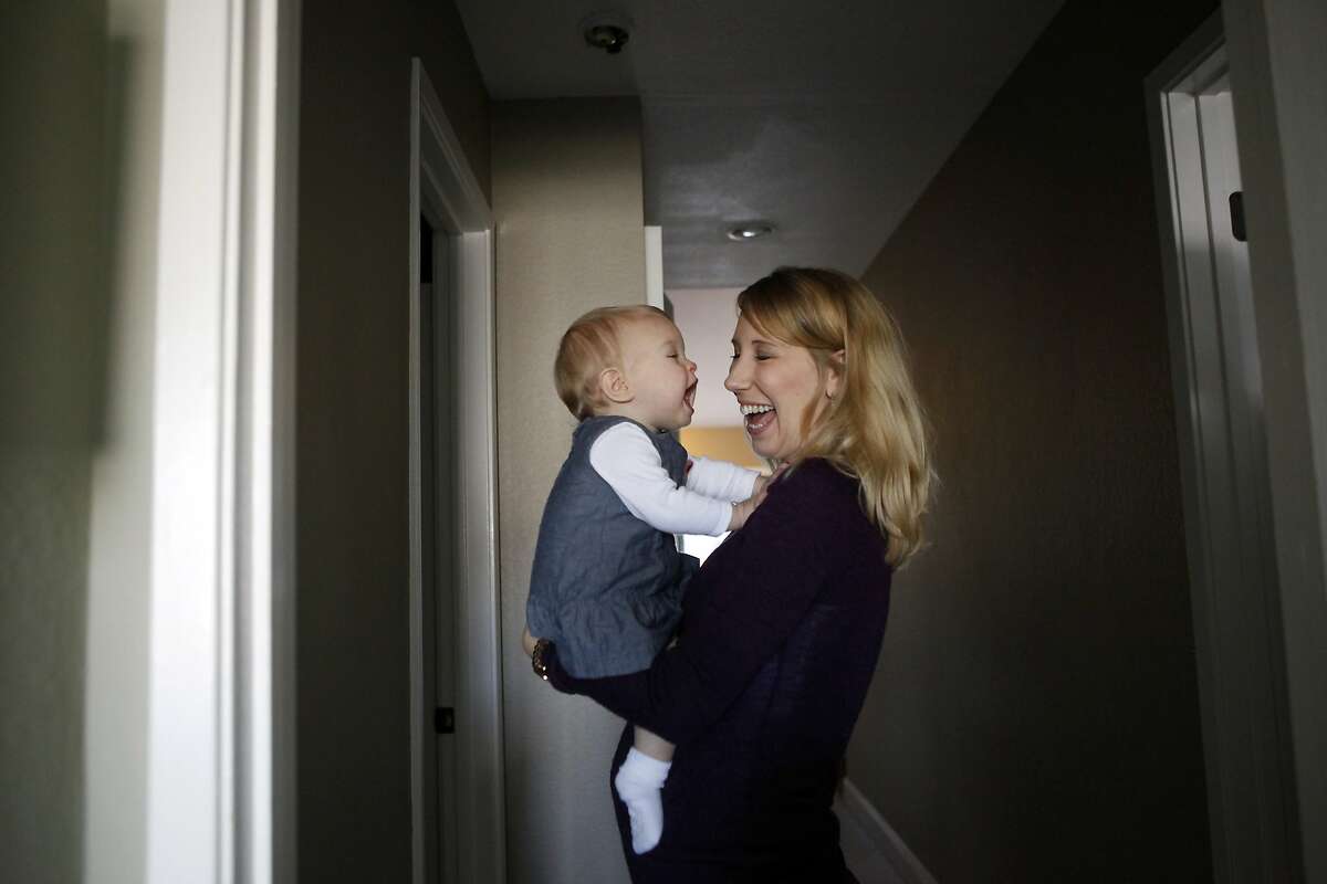 Elizabeth Barnett holds her 10 month old daughter Quinn at their home in San Jose, CA, Thursday, January 25, 2014. Elizabeth lost her first baby when she was diagnosed with severe preeclampsia 23 weeks into her pregnant in 2011. She was able to recover and have a healthy, preeclampsia-free pregnancy with Quinn and now is pregnant again with a second girl.