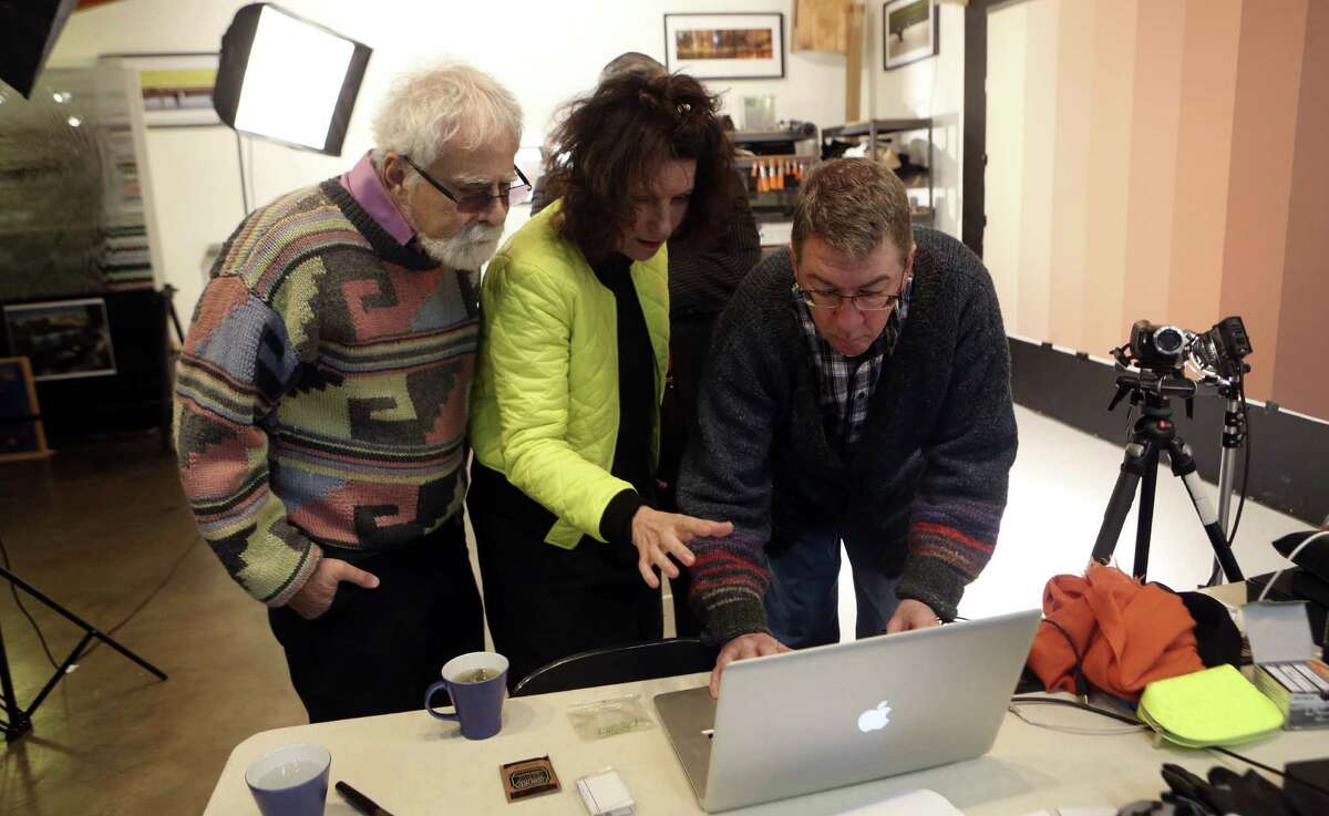 David Rubin (from left), French video artist Sylvie Blocher and Ansen Seale view footage Blocher filmed for a video portrait series about Latinos.