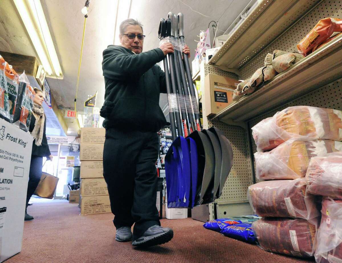 Greenwich Hardware Store employee, Emilio Gomez, stocks snow shovels inside the store in Greenwich, Tuesday afternoon, Feb. 4, 2014. Gomez said the store has had a good winter season selling lots of shovels and winter items such as ice-melt and sleds. The National weather Service is calling for another winter storm early Wednesday morning that is forecasted to bring snow, sleet and freezing rain to Greenwich with the accumulation of 4-8 inches of snow and ice by the time the storm passes Wednesday night.