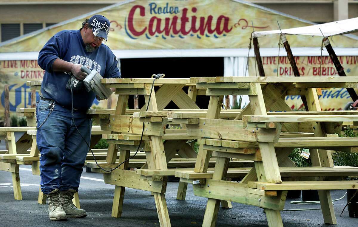 James Diaz, a volunteer worker at The San Antonio Stock Show and Rodeo, sands off the edges of some of the 30 new picnic tables that he and other volunteers made, gearing up for the opening of the stock show on Thursday. Tuesday, Feb. 4, 2014.