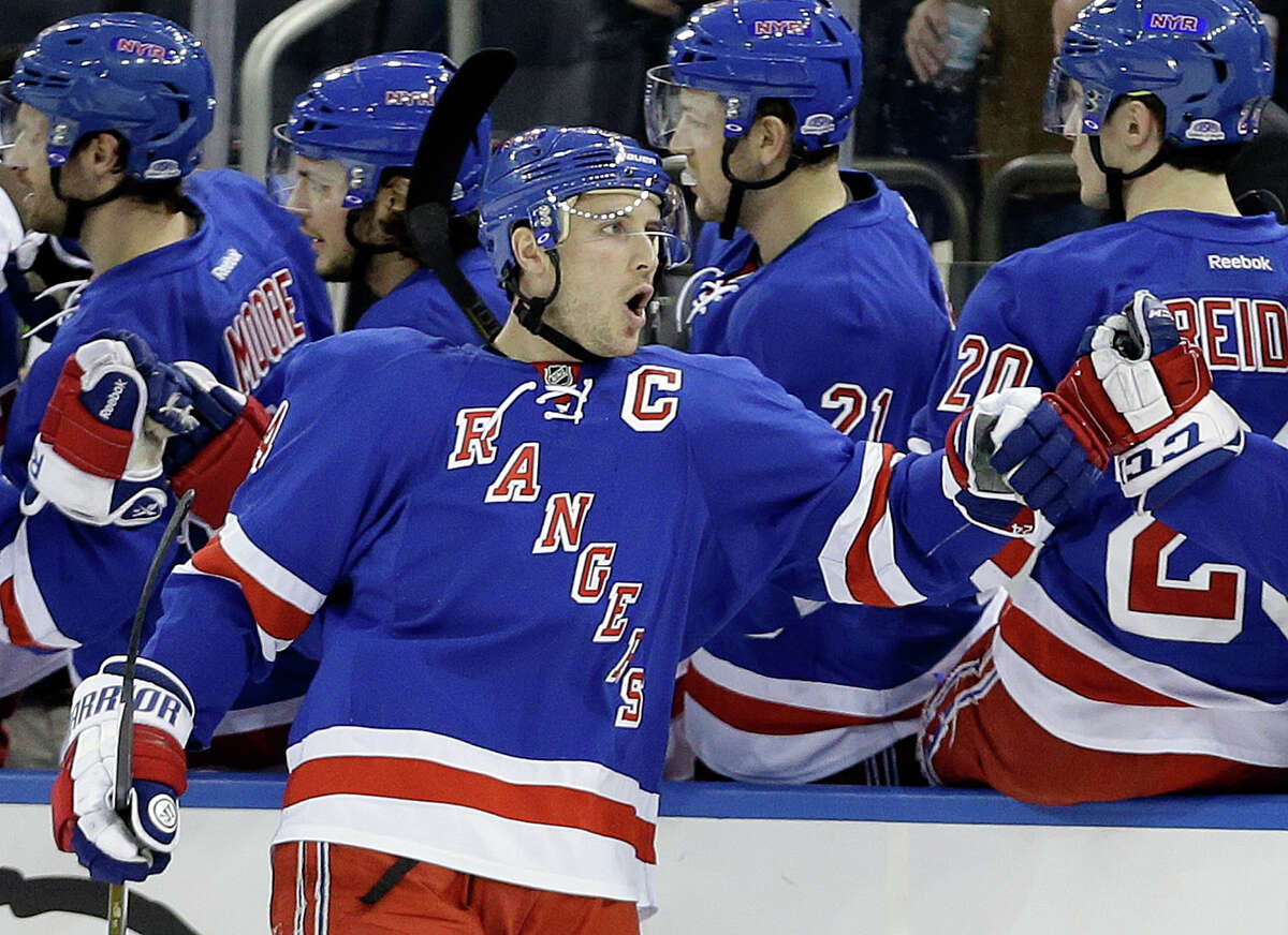 New York Rangers' Ryan Callahan (24) celebrates with teammates after scoring a goal during the first period of an NHL hockey game against the Colorado Avalanche, Tuesday, Feb. 4, 2014, in New York. (AP Photo/Frank Franklin II) ORG XMIT: MSG101