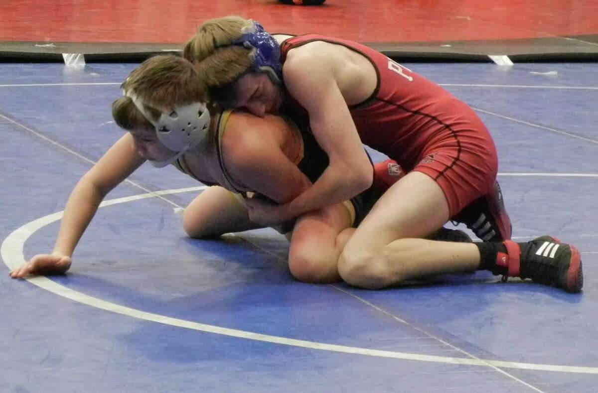 Jack Price, of Fairfield Warde, in red, wrestles Josh Kowalksi, of Simsbury, to finish in fifth place in the 108-pound division of the Warde Invitational on Jan. 4. Warde won the team championship for the fifth time in six years. The Mustangs were scheduled to play host to perennial FCIAC champion Danbury on Wednesday at 6 p.m. but the match was called off because of the snow storm.