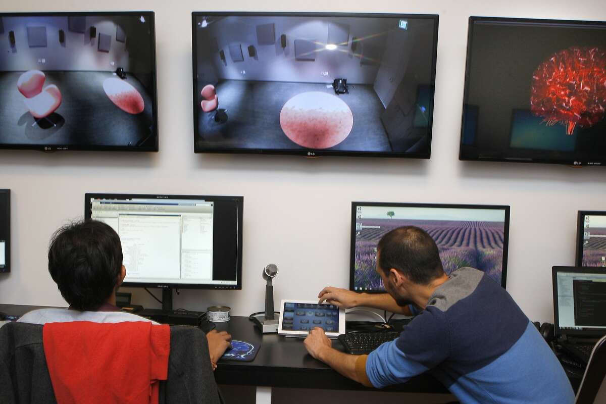 Biomedical engineer Rajad Jain (left) and interactive media designer Roger Anguera (right) work in the control room at the UCSF Neuroscience Imaging Center in San Francisco, Calif., on Tuesday, February 4, 2014.