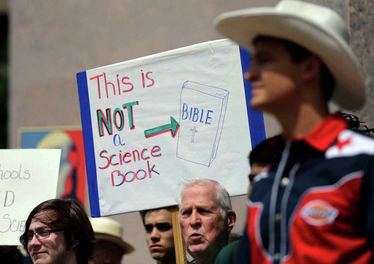 FILE - In this Sept. 17, 2013 file photo, pro-science supporters rally prior to a State Board of Education public hearing on proposed new science textbooks, in Austin, Texas. The Texas Board of Education is poised to tighten rules on who can serve on citizen review panels that scrutinize proposed textbooks for use statewide, hoping to tamp down future controversies over the teaching of evolution and other issues. (AP Photo/Eric Gay, File)