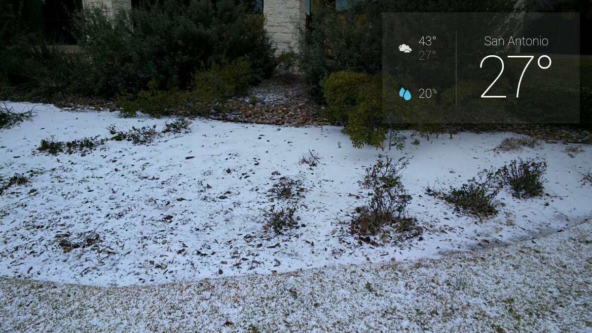 A reader uses Google Glass to take photos of graupel, which is snow encased in ice, on Thursday morning, Feb. 6, 2014.