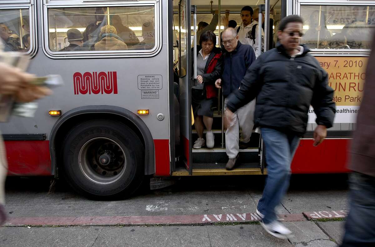 MUNI riders transfer at the bus stop off Geary Street.