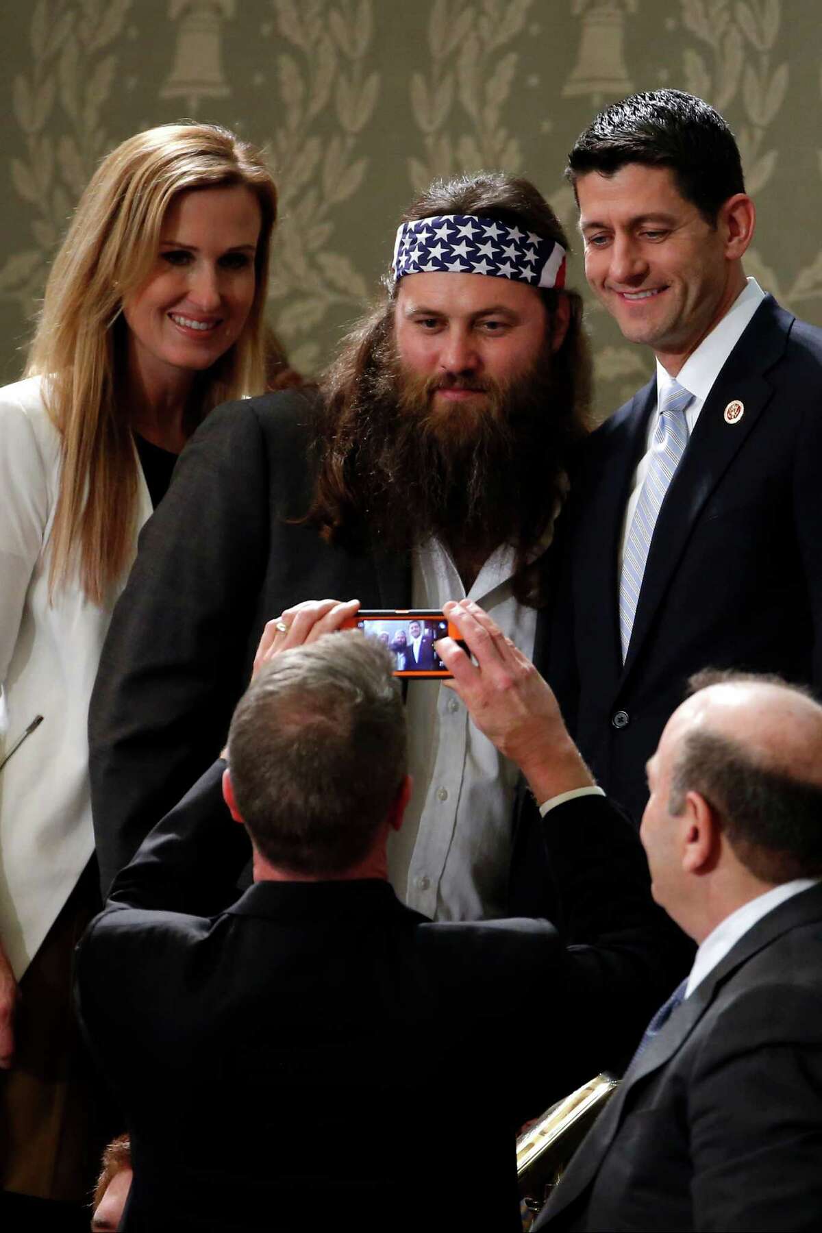 "Duck Dynasty's" Willie Robertson, center, and his wife Korie, pose with Rep. Paul Ryan, R-Wis., before President Barack Obama's State of the Union address on Capitol Hill in Washington, Tuesday, Jan. 28, 2014.