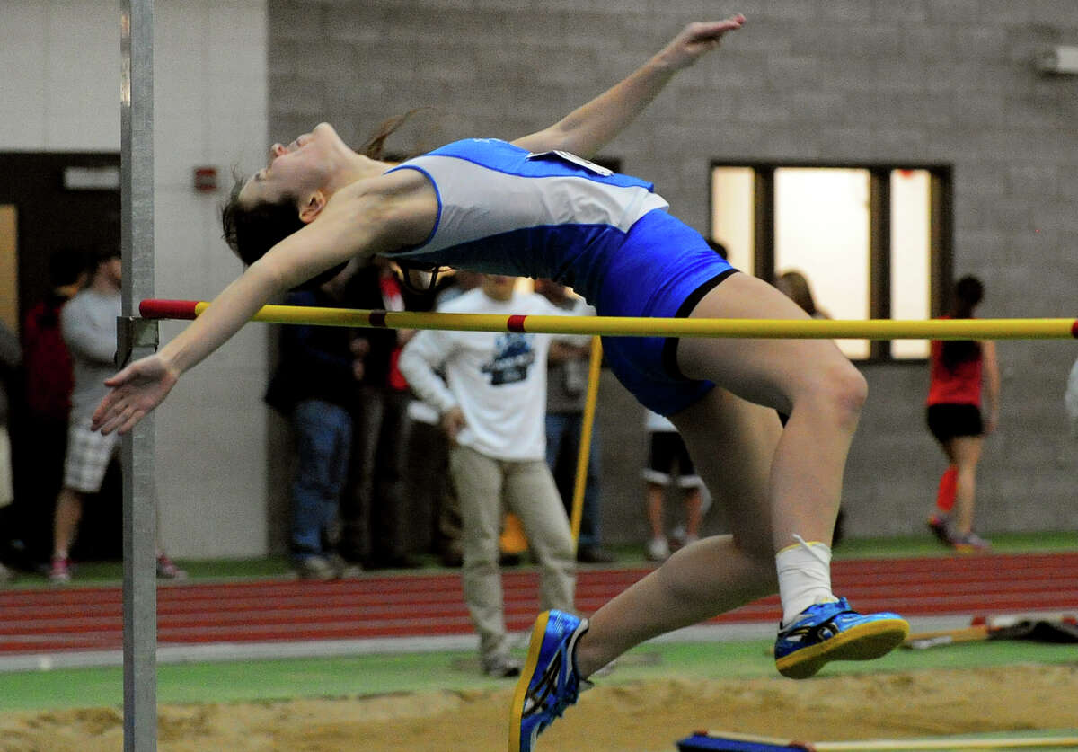 Darien's Catherine Lacy competes in the high jump, during Class L Championship track action at Hillhouse High School's Floyd Little Athletic Center in New Haven, Conn. on Thursday February 6, 2014.