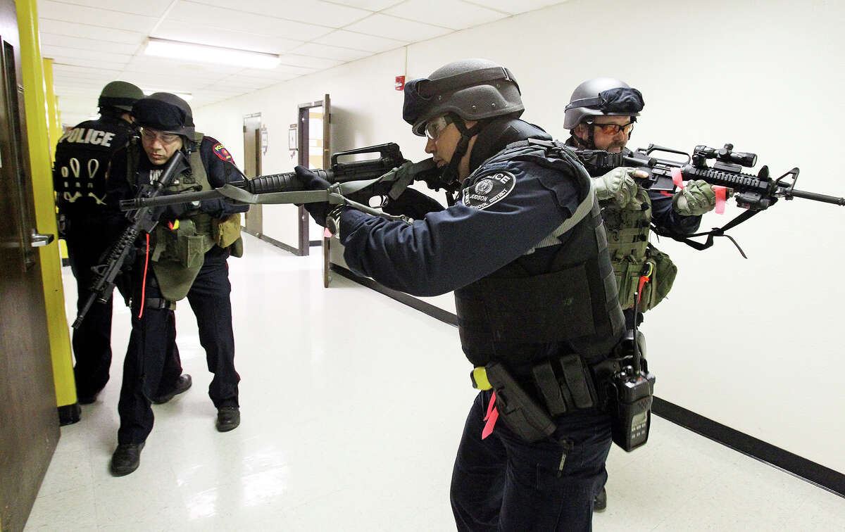 Team members prepare to check out a classroom as the Judson ISD Emergency Response team practices with a drill at the Judson Education Community Center on February 6, 2014.