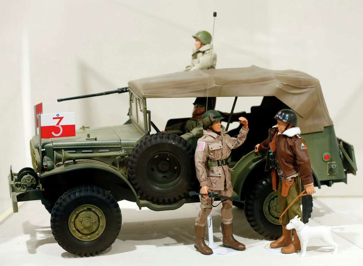 This Jan. 31, 2014 photo shows a Gen. George Patton G.I. Joe action figure, right, and other G.I. Joes in a display at the New York State Military Museum in Saratoga Springs, N.Y. A half-century after the 12-inch doll was introduced at a New York City toy fair, the iconic action figure is being celebrated by collectors with a display at the military museum, while the toy's maker plans other anniversary events to be announced later this month.