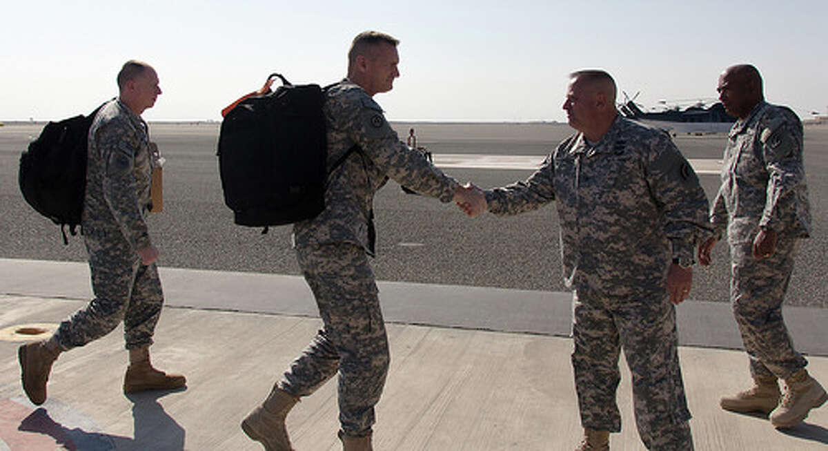 Major Gen. Patrick Murphy, the Adjutant General of New York, shakes hands with Col. Albert Ricci Sr., commander of the 42nd Combat Aviation Brigade, during Murphy's visit to on Feb. 7, 2014, on Camp Buehring, Kuwait. The 42nd CAB is deployed to Kuwait to operate rotary winged aircraft in support of Operation Enduring Freedom. (1st Lt. Jean Marie Kratzer/New York Army National Guard)