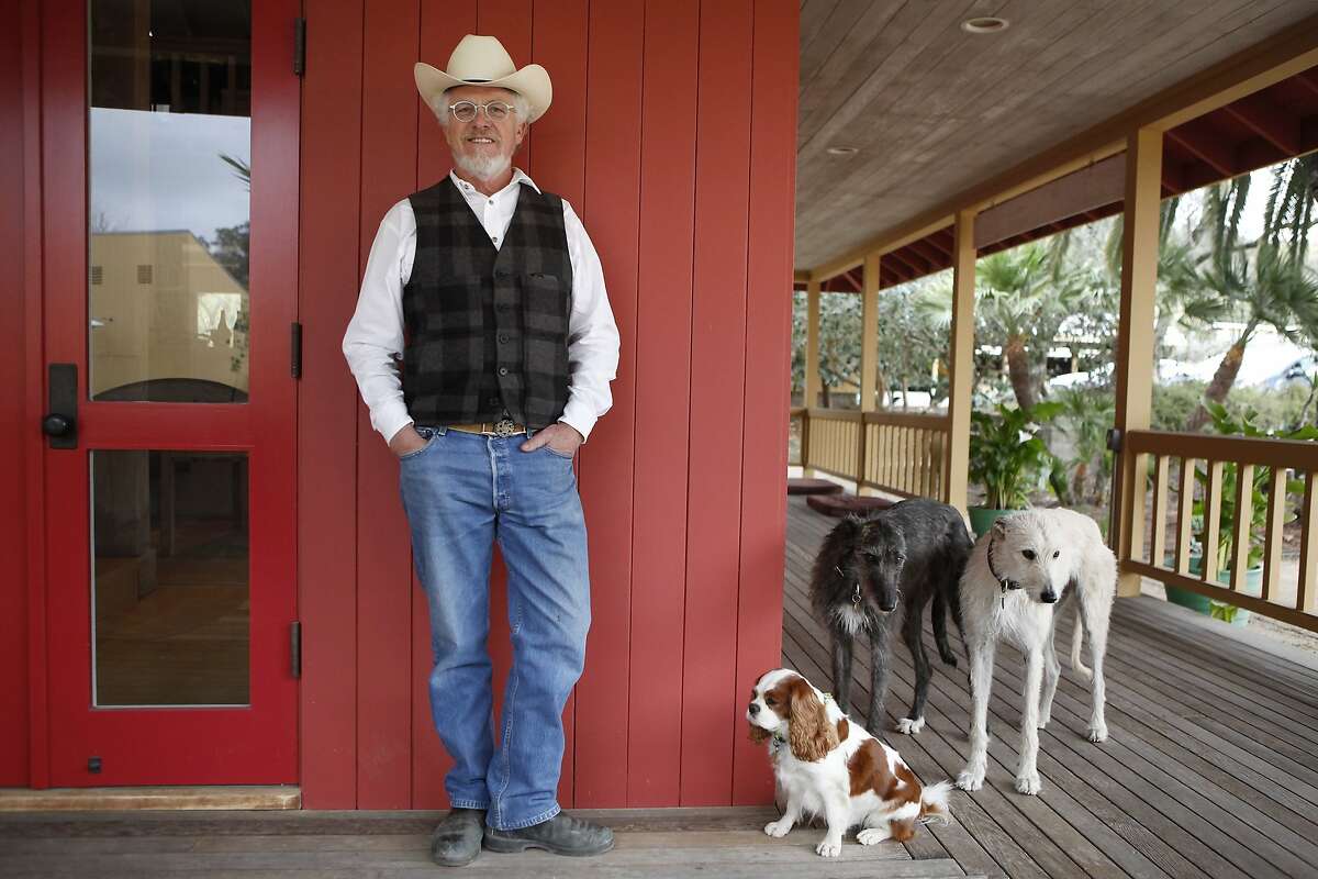 Lee Hudson poses for a portrait with his dogs outside his office at his Hudson Ranch property in Napa, CA, Wednesday, January 29, 2014.