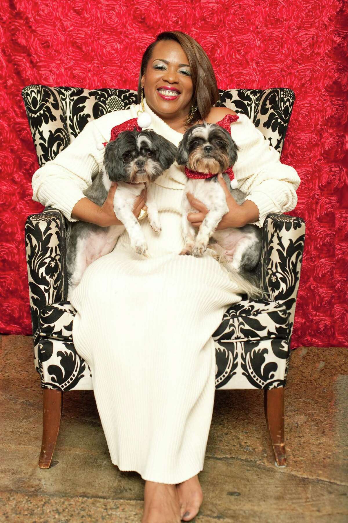 Jackie Adams, owner and president of Melodrama Boutique on Almeda, with her father-son Shih Tzus.