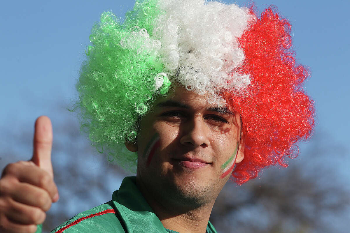 Luis Gomez, of Edinburg, wears a tri-color wig while waiting for the start an international friendly soccer game between the Mexican National Team and South Korea Republic at the Alamodome, Wednesday, Jan. 29, 2014.