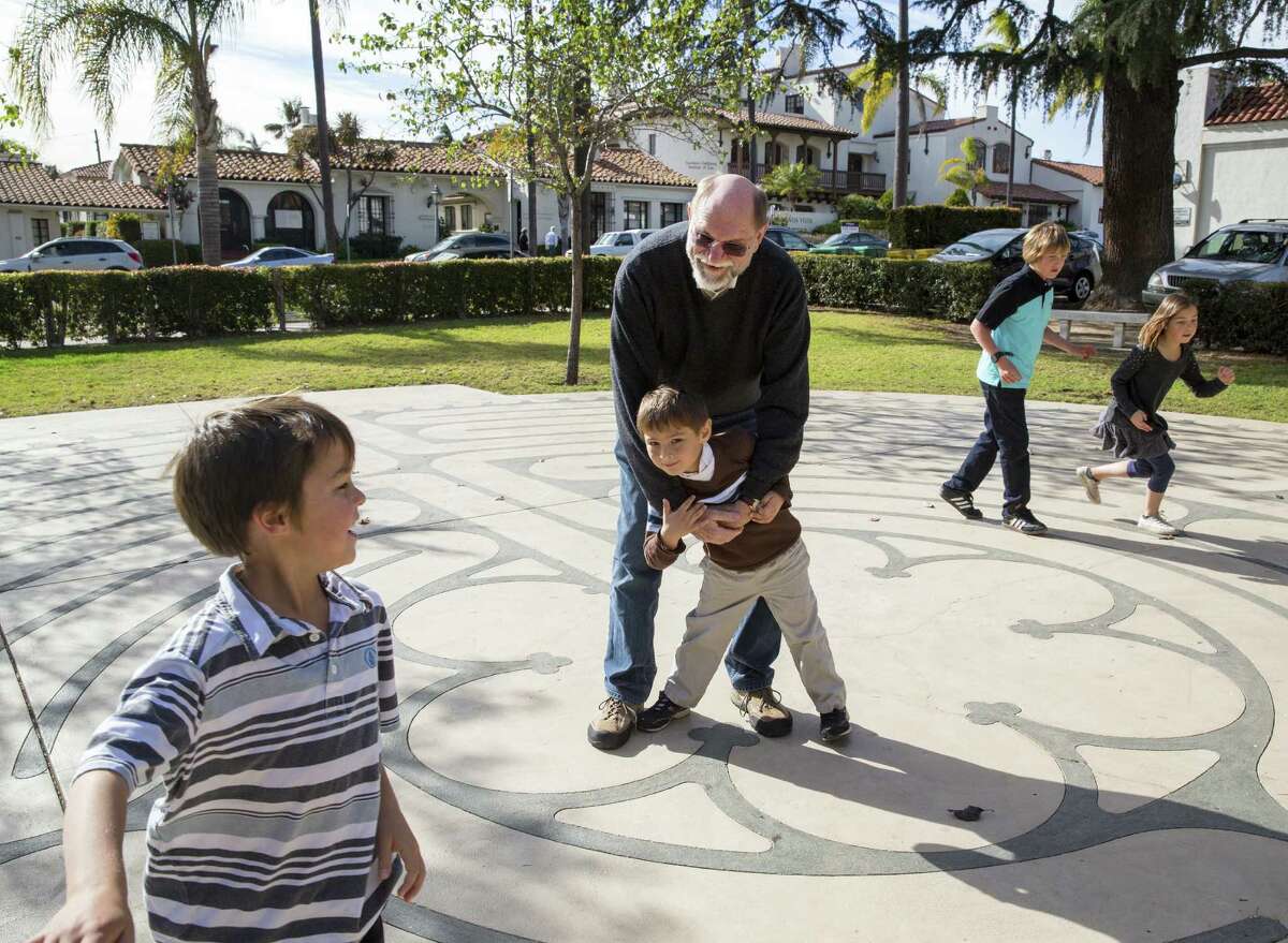 Vern L. Bengtson plays with grandchildren Zadin, Tyler, Boz and Zoe. Bengtson has co-written “Families and Faith: How Religion is Passed Down Across Generations.”